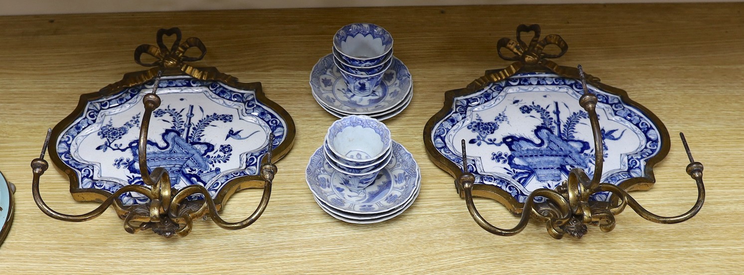 A pair of 19th century ormolu blue and white Delft wall sconces and with blue and white Chinese tea bowls and saucers forming the drip pans